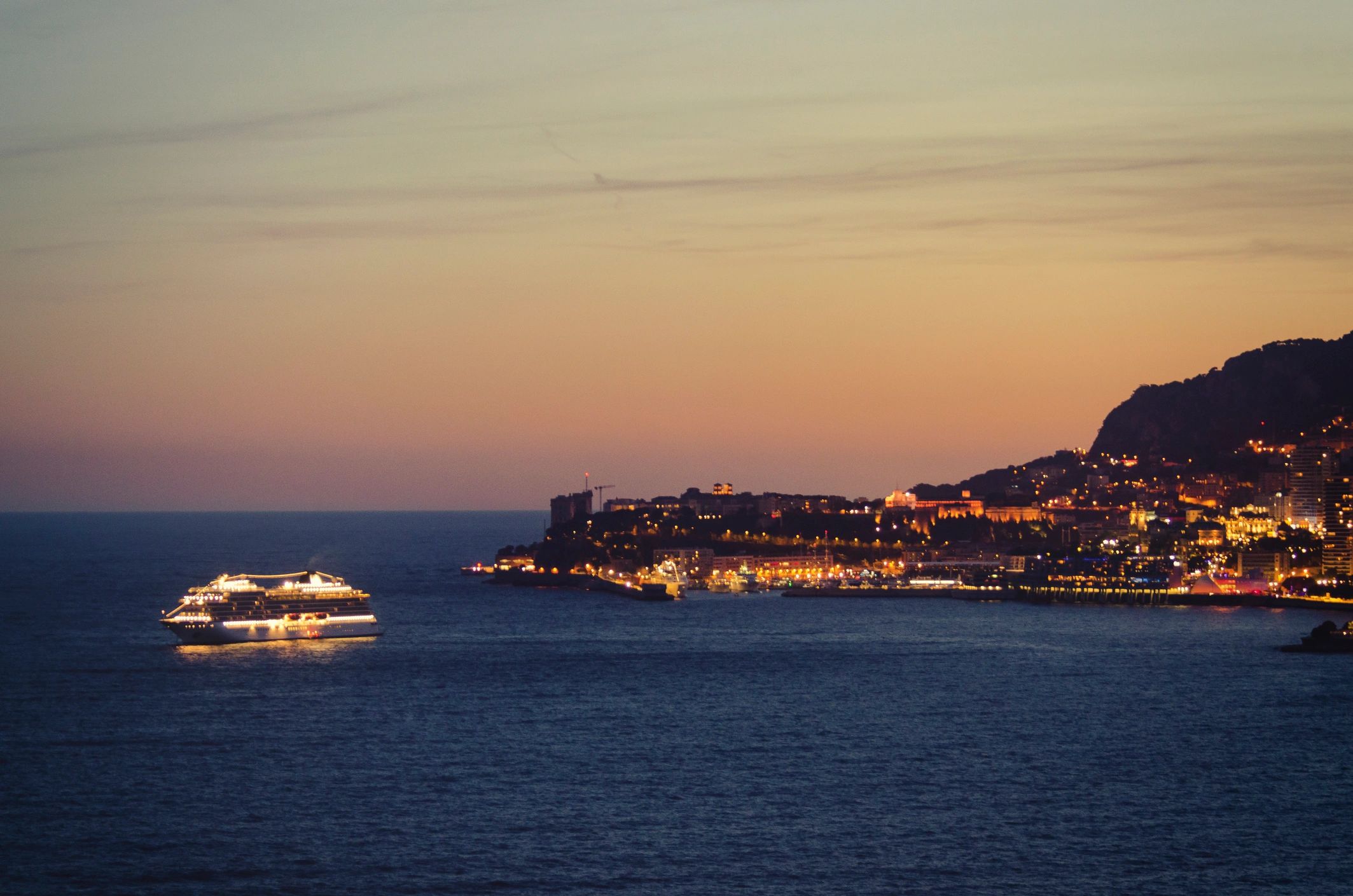Cruise ship sailing at sunset